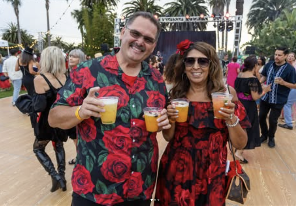 man and woman on a dance floor holding drinks